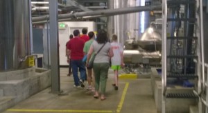 Alex (in "Staff" shirt and neon shorts) during the brew tour.  Blurry because I was walking and snapping the pic, and the phone camera is no good at that.